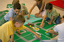 Children playing with letter map